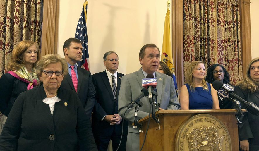 In this Thursday, Sept. 27, 2018 photo, Assembly Speaker Craig Coughlin, center at lectern, speaks about a new anti-harassment policy that he and Senate Majority Leader Loretta Weinberg, left foreground, helped author, in Trenton, N.J. Weinberg revealed for the first time on Friday that she was groped and forcibly kissed by a middle-aged man seven decades ago when she was just 13. (AP Photo/Michael Catalini)