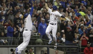 Milwaukee Brewers&#39; Ryan Braun is congratulated by third base coach Ed Sedar after hitting a home run during the first inning of a baseball game against the Detroit Tigers Friday, Sept. 28, 2018, in Milwaukee. (AP Photo/Morry Gash)