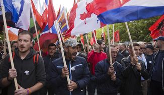 Thousands of supporters of Kosovo&#39;s opposition Self-Determination shouting slogans and waving flags of the world countries march through toward Skanderbeg Square on Saturday, Sept. 29, 2018, in Kosovo capital Pristina. Thousands of people in Kosovo are protesting their president&#39;s willingness to include a possible territory swap with Serbia in the ongoing negotiations to normalize relations between the two countries. (AP Photo/Visar Kryeziu)