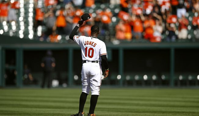 Baltimore Orioles center fielder Adam Jones tips his cap as fans cheer for him before a baseball game against the Houston Astros, Sunday, Sept. 30, 2018, in Baltimore. (AP Photo/Patrick Semansky)