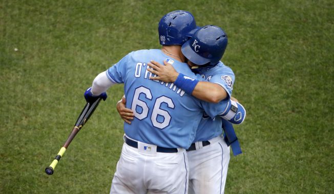Kansas City Royals&#x27; Whit Merrifield hugs Ryan O&#x27;Hearn (66) after Merrifield came out of the game during the eighth inning of a baseball game Sunday, Sept. 30, 2018, in Kansas City, Mo. (AP Photo/Charlie Riedel)