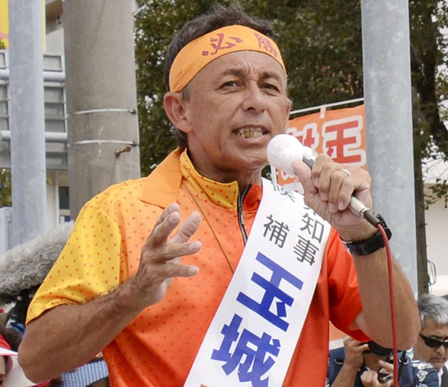 In this Sept. 27, 2018, photo, Denny Tamaki, a legislator, delivers a speech during his election campaign for Okinawa governor in Uruma city, Okinawa. Okinawans are choosing a governor in an election Sunday, Sept. 30, that many see hinging on how voters feel about the American military presence on the southwestern Japanese island.(Kyodo News via AP)