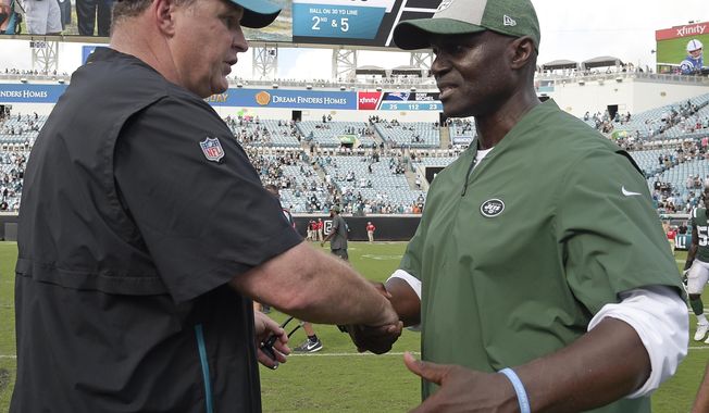 Jacksonville Jaguars head coach Doug Marrone, left, and New York Jets head coach Todd Bowles shake hands after an NFL football game, Sunday, Sept. 30, 2018, in Jacksonville, Fla. (AP Photo/Phelan M. Ebenhack)