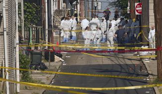 Federal and local authorities investigate along North Hall Street in Allentown, Pa., Sunday, Sept. 30, 2018, after a fiery car explosion rocked the neighborhood on Saturday night. Police confirmed several fatalities. (Harry Fisher/The Morning Call via AP)