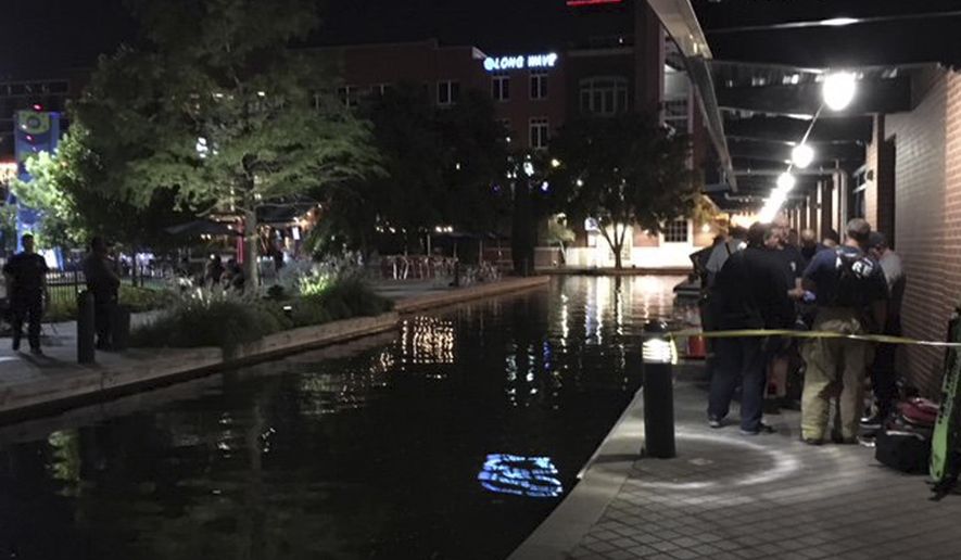 This photo provided by the Oklahoma City Fire Department, shows the scene at the Bricktown canal in Oklahoma City, Sunday, Sept. 30, 2018, where one man died and another is in critical condition after being electrocuted in the canal. (Oklahoma City Fire Department via AP)