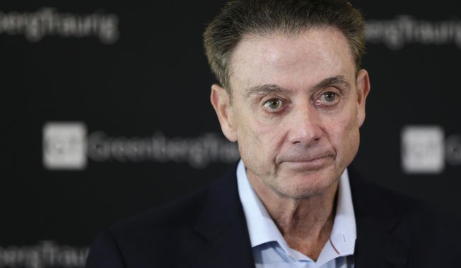 FILE- In this Feb. 21, 2018 file photo, former Louisville basketball Hall of Fame coach Rick Pitino talks to reporters during a news conference in New York. A recruiter, a coach and a former Adidas executive are scheduled to go on trial in New York in a criminal case that exposed corruption in several top U.S. college basketball programs. It also led to the firing of Pitino and sidelined the playing career of standout recruit Brian Bowen Jr. (AP Photo/Seth Wenig, File) **FILE**