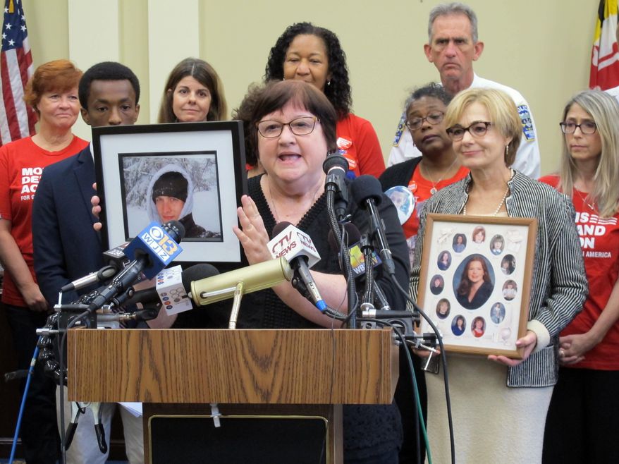 Dorothy Paugh holds a photo of her son, Peter Lapa Lilly, during a news conference in Annapolis, Maryland, on Monday, Oct. 1, 2018. Lawmakers and gun-control advocates held the news conference to discuss a new law taking effect in Maryland that enables courts to temporarily restrict firearms access for people found to be a risk to themselves or others. Paugh said the law could have helped get a gun away from her son, who shot himself in 2012. (AP Photo/Brian Witte)
