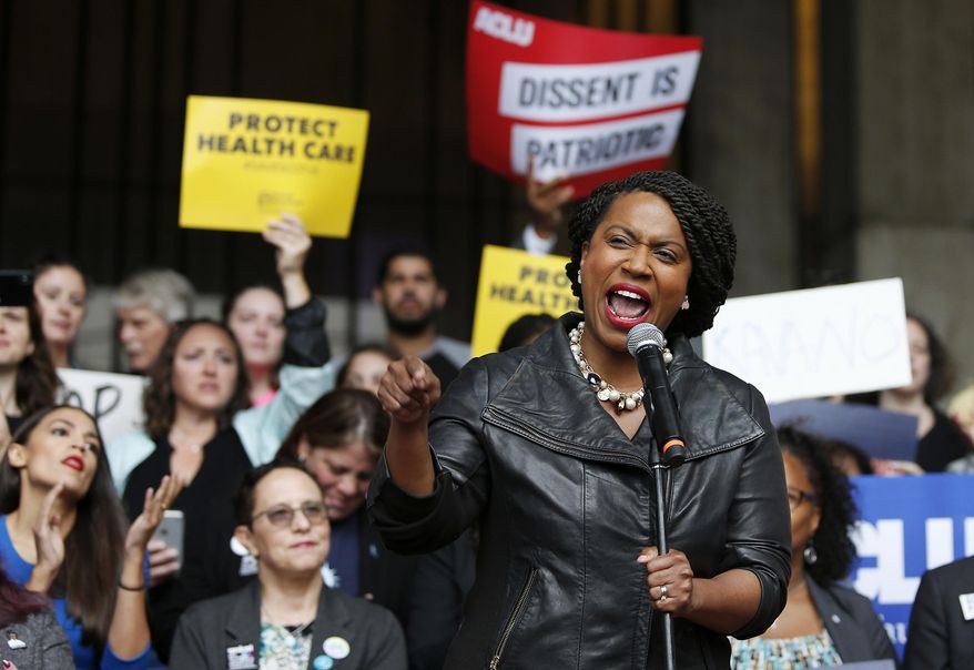 Ayanna Pressley, the democratic winner of the Massachusetts 7th congressional district speaks at a rally at City Hall ahead of an appearance by Sen. Jeff Flake, R-Ariz., at the Forbes 30 Under 30 Summit, Monday, Oct. 1, 2018, in Boston. (AP Photo/Mary Schwalm) **FILE***