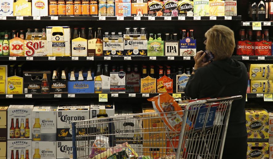 A customer looks over the beer selection at Crest Foods in Oklahoma City, Monday, Oct. 1, 2018. Beginning Monday grocery stores and convenience stores in Oklahoma can legally sell wine and strong beer. (AP Photo/Sue Ogrocki)
