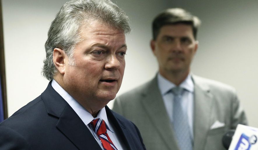 FILE - In this Thursday, July 19, 2018, file photo, Mississippi Attorney General Jim Hood, left, speaks at a news conference in Jackson, Miss. Fourth-term Attorney General Hood said in a statement Monday, Oct. 1, 2018, that he will announce his candidacy for governor Wednesday, Oct. 3 in his hometown of Houston, Miss. (AP Photo/Rogelio V. Solis, File)