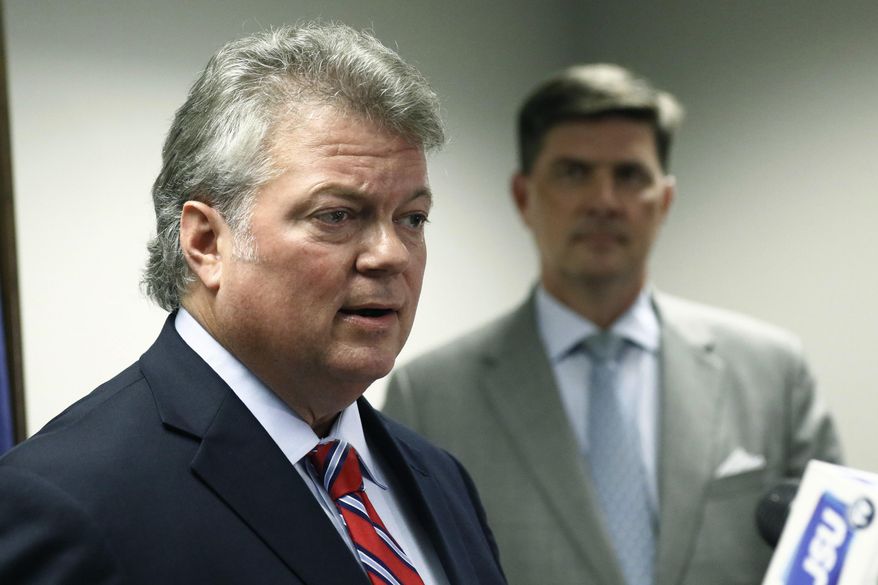 FILE - In this Thursday, July 19, 2018, file photo, Mississippi Attorney General Jim Hood, left, speaks at a news conference in Jackson, Miss. Fourth-term Attorney General Hood said in a statement Monday, Oct. 1, 2018, that he will announce his candidacy for governor Wednesday, Oct. 3 in his hometown of Houston, Miss. (AP Photo/Rogelio V. Solis, File)