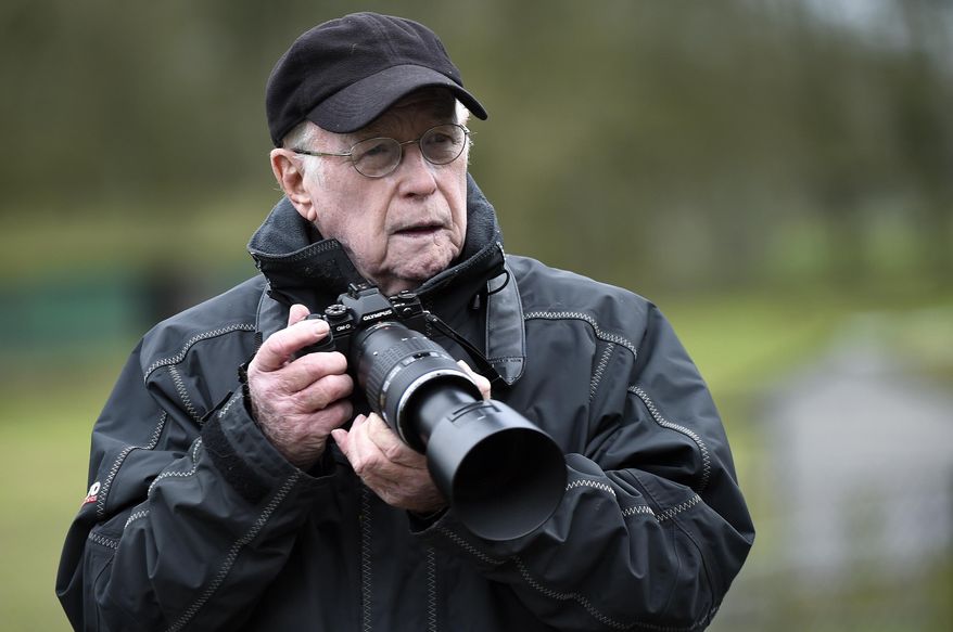In this February 2016 photo, Max Nash takes photos in Bedfordshire. Nash, who covered the conflicts in Southeast Asia and the Middle East and helped nurture a new generation of female photojournalists during more than 40 years with The Associated Press, died Friday, Sept. 28, 2018, after collapsing at home. He was 77. (Tony Margiocchi via AP)