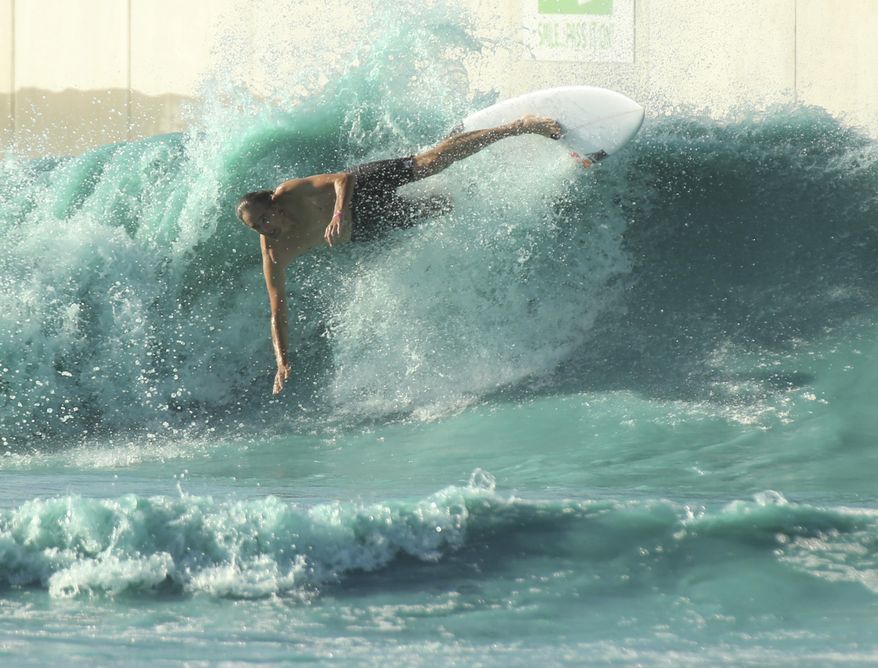 In this Saturday, July 14, photo-A surfer takes a spill while battling the waves at the BSR Surf resort near Waco, Texas. The Centers for Disease Control and Prevention is testing at BSR Cable Park's Surf Resort for Naegleria fowleri, which is commonly referred to as a "brain-eating amoeba," officials said. (Rod Aydelotte/Waco Tribune Herald, via AP)