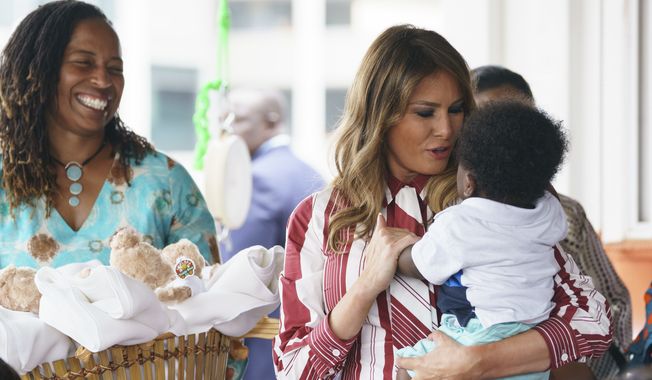 First lady Melania Trump holds a baby as she visits Greater Accra Regional Hospital in Accra, Ghana, Tuesday, Oct. 2, 2018. The first lady is visiting Africa on her first big solo international trip, aiming to make child well-being the focus of a five-day, four-country tour. (AP Photo/Carolyn Kaster)