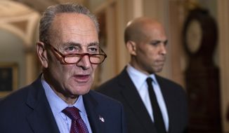 Senate Minority Leader Chuck Schumer, D-N.Y., with Sen. Cory Booker, D-N.J., at right, pauses as they speak to reporters about the political battle for confirmation of President Donald Trump&#39;s Supreme Court nominee, Brett Kavanaugh, following a closed-door Democratic policy meeting, at the Capitol in Washington, Tuesday, Oct. 2, 2018. (AP Photo/J. Scott Applewhite) **FILE**