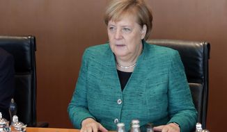 German Chancellor Angela Merkel attends the weekly cabinet meeting at the chancellery in Berlin, Germany, Tuesday, Oct. 2, 2018. (AP Photo/Michael Sohn)