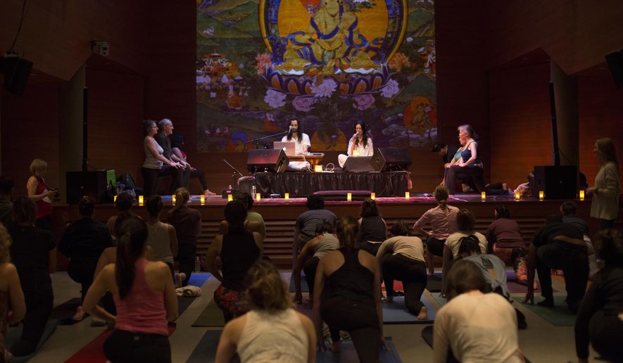 This Jan. 20, 2017 photo provided by the Rubin Museum of Art shows yoga participants in "Swear In, Breathe Out," a special yoga class offered in response to Inauguration Day at the Rubin Museum in New York. The class was taught by Sarah Platt-Finger, accompanied by live music from Aya & Tyler. (Asya Gorovits/Rubin Museum of Art via AP)