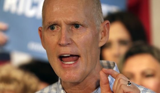 FILE- In this Sept. 6, 2018 file photo, Fla. Gov. Rick Scott speaks at a Republican rally in Orlando, Fla. Incumbent Democratic Sen. Bill Nelson and challenger Gov. Rick Scott meet in the first of several debates in their campaign for a highly competitive U.S. Senate seat Tuesday, Oct. 2, 2018 in Miramar, Fla. (AP Photo/John Raoux, File)