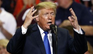 President Donald Trump gestures as he speaks at a rally Tuesday, Oct. 2, 2018, in Southaven, Miss. (AP Photo/Rogelio V. Solis)