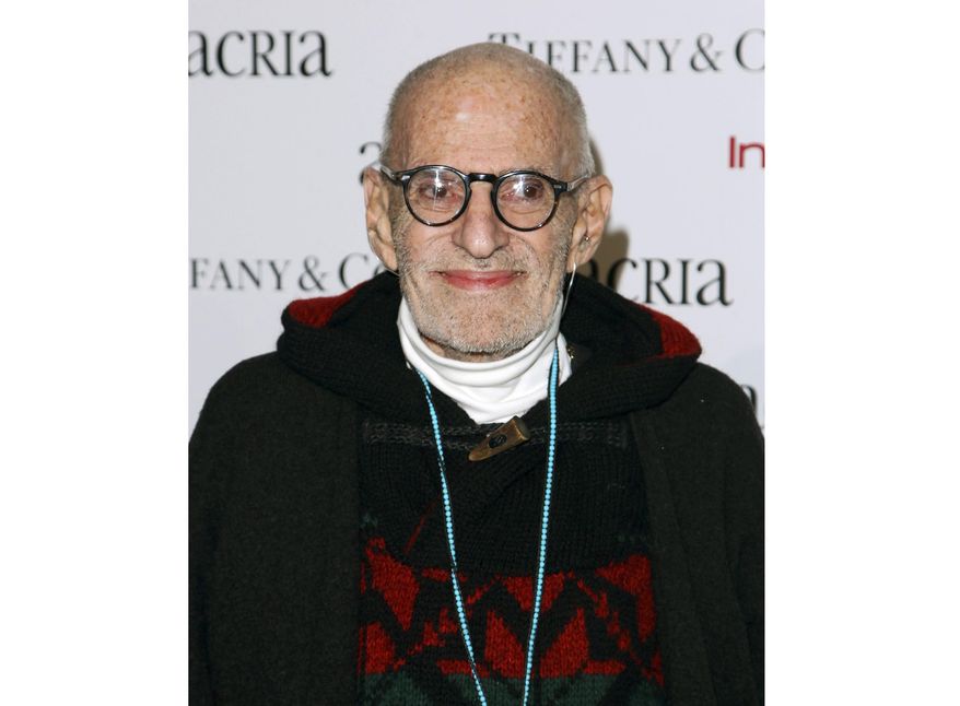 FILE - In this Dec. 10, 2014 file photo, playwright Larry Kramer attends Acria's 19th Annual Holiday Dinner Benefit in New York. Bill Goldstein has been tapped to write the authorized biography of Kramer by Henry Holt and Company. The yet-untitled book will draw on interviews with Kramer; his husband David Webster; friends and foes; as well as papers in Kramer’s archives at Yale University. (Photo by Donald Traill/Invision/AP, File)