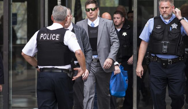 Chicago police officer Jason Van Dyke, wearing sunglasses, is escorted out of the Leighton Criminal Court Building in Chicago, Tuesday, Oct. 2, 2018, after testifying in his first degree murder trial for the shooting death of Laquan McDonald. (Ashlee Rezin/Chicago Sun-Times via AP)