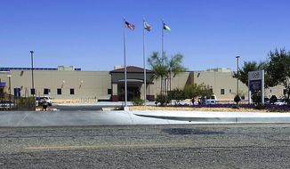 FILE - This May 19, 2015, file photo shows the Adelanto Detention Center in Adelanto, Calif., a desert community 70 miles (113 kilometers) northeast of Los Angeles. Federal inspectors found nooses made from bedsheets hanging in more than a dozen cells during an inspection in May, 2018, The OIG issued a scathing report after visiting the privately-run detention facility run by the GEO Group. There were at least seven suicide attempts at the facility between December 2016 and October 2017, and a 32-year-old man killed himself by hanging in March 2017, according to the report. (James Quigg/The Daily Press via AP, File)