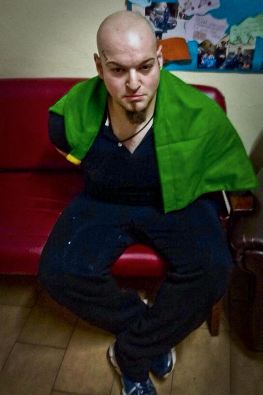 This Saturday, Feb. 3, 2018 file photo shows a man identified by the Italian Carabinieri, paramilitary police, as Luca Traini. An Italian man with extreme right-wing political views has been convicted in a shooting rampage targeting immigrants and sentenced to 12 years in prison. Luca Traini, 28, was arrested by police in the main square of the central Italian city of Macerata following the rampage that injured six immigrants and terrorized the city last February. (ANSA via AP)