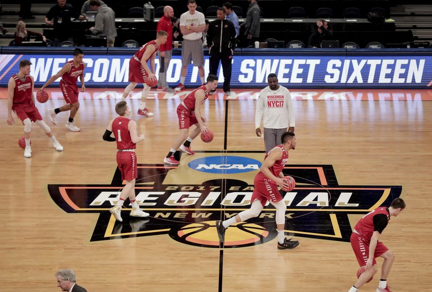 FILE - In this March 23, 2017, file photo, Wisconsin players dribble across the court during practice at Madison Square Garden in New York. Defending national champion Villanova will play at least three times at Madison Square Garden during the upcoming season, part of a 2018-19 college basketball schedule that also features Duke, Kentucky and Syracuse visiting The World's Most Famous Arena. Florida, Maryland, Notre Dame, Oklahoma, Oregon and West Virginia are among the other programs headed to MSG. (AP Photo/Julie Jacobson, File)