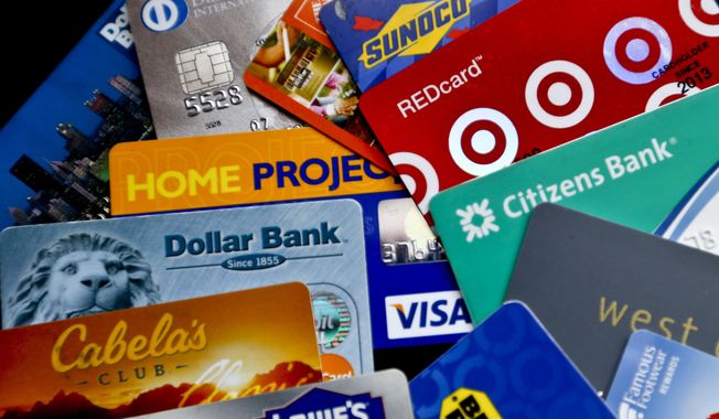 In this Jan. 31, 2018, file photo, an assortment of credit cards and rewards cards are shown in Zelienople, Pa. (AP Photo/Keith Srakocic, File)