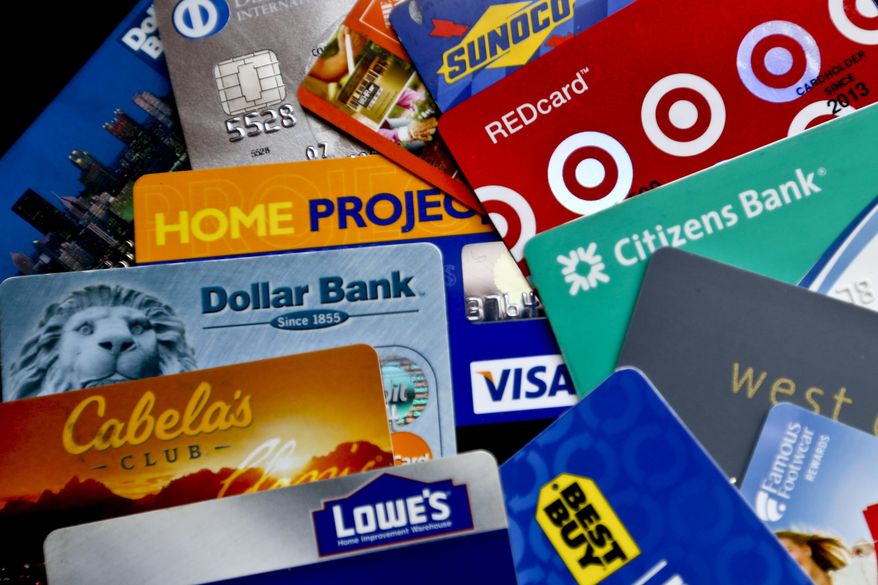 In this Jan. 31, 2018, file photo, an assortment of credit cards and rewards cards are shown in Zelienople, Pa. (AP Photo/Keith Srakocic, File)