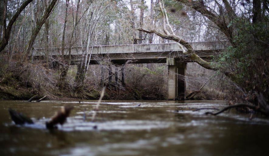 FILE- This Feb. 22, 2018 photo shows a bridge that spans the Apalachee River at Moore's Ford Road where in 1946 two young black couples were stopped by a white mob who dragged them to the riverbank and shot them multiple times in Monroe, Ga. The brazen mass lynching horrified the nation that year but no one was ever indicted and investigations over the years failed to solve the case. More than 70 years after a grand jury failed to indict anyone in the lynching of two young black couples in rural Georgia, a historian is seeking the transcripts from the grand jury proceedings. A federal appeals court is set to hear arguments in the case Wednesday, Oct. 3, 2018. (AP Photo/David Goldman, File)