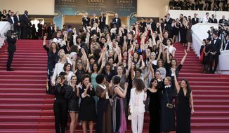 In this May 12, 2018, file photo, 82 film industry professionals stand on the steps of the Palais des Festivals to represent, what they describe as pervasive gender inequality in the film industry, at the Cannes Film Festival in Cannes, France. The #MeToo movement has gone far beyond the movies, but Hollywood remains ground zero in a cultural eruption that began 12 months ago with the revelations about Harvey Weinstein. (Photo by Vianney Le Caer/Invision/AP, File)