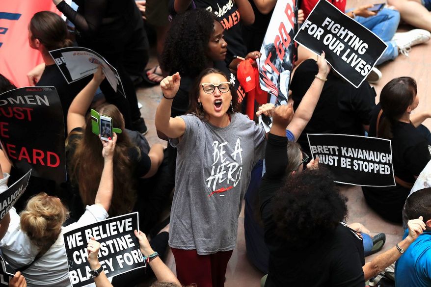 Demonstrators chant slogans on Capitol Hill to protest Supreme Court nominee Brett M. Kavanaugh. A national rally is planned for Saturday. (Associated Press)