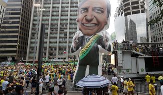 A large, inflatable doll of presidential candidate Jair Bolsonaro, stands during a rally in Sao Paulo, Brazil, Sunday. The country will hold its general elections on Oct. 7. (ASSOCIATED PRESS)