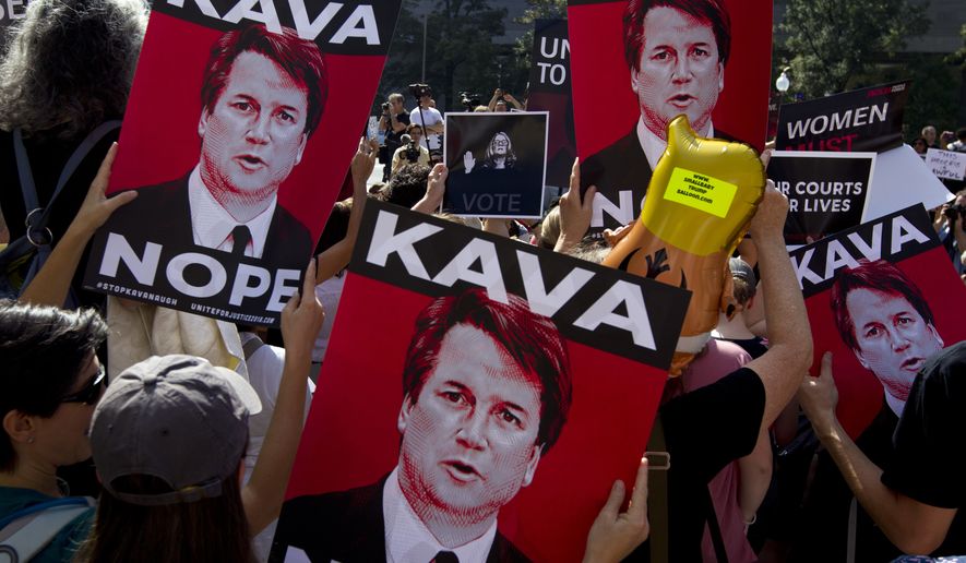 Demonstrators protest against Supreme Court nominee Brett Kavanaugh, as they march to the U.S. Supreme Court, on Thursday, Oct. 4, 2018, in Washington. (AP Photo/Jose Luis Magana)