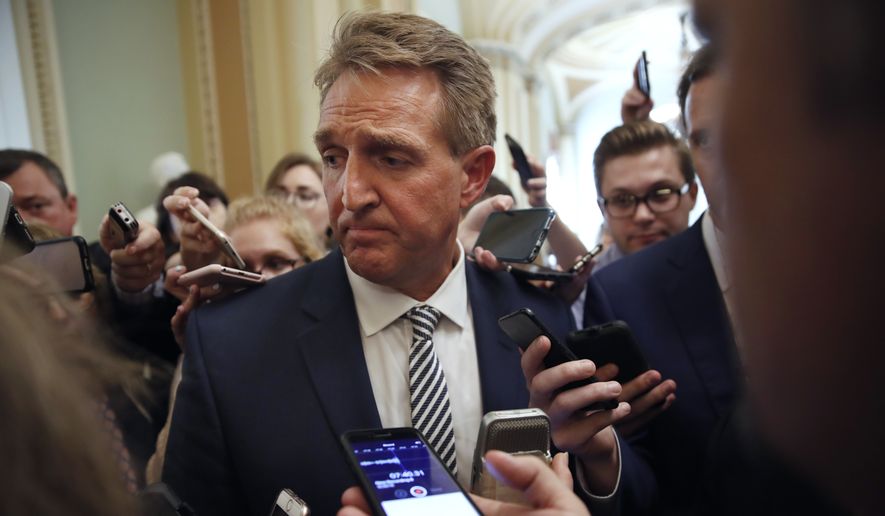 Sen. Jeff Flake, R- Ariz., pauses while he is questioned by reporters about Supreme Court nominee Brett Kavanaugh, Friday Sept. 28, 2018, on Capitol Hill in Washington. (AP Photo/Jacquelyn Martin) ** FILE **