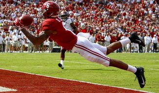 FILE - In this Sept. 22, 2018, file photo, Alabama wide receiver DeVonta Smith (6) catches a pass for a touchdown during the first half of an NCAA college football game against Texas A&amp;amp;M,  in Tuscaloosa, Ala. No. 1 Alabama has one of the SEC&#39;s most talented collection of receivers, and the Crimson Tide is spreading it around among Jerry Jeudy, Henry Ruggs III, DeVonta Smith and Jaylen Waddle. (AP Photo/Butch Dill, File)