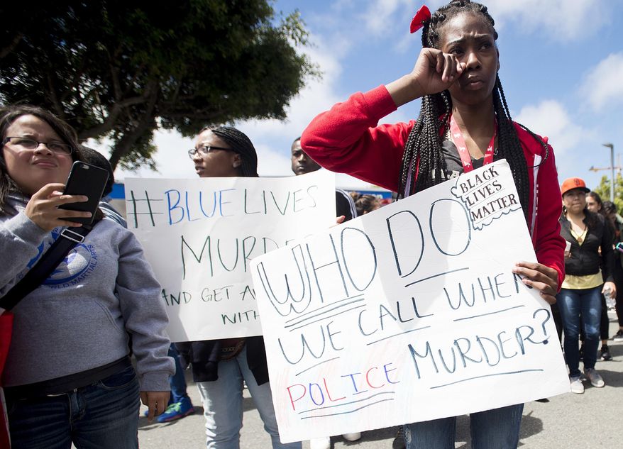 In this July 9, 2016, file photo, Emani Williams joins protesters rallying against the fatal shootings by police of black men in San Francisco. Five black women and a black man are suing the San Francisco Police Department alleging racial bias, claiming they were targeted for arrest by a department plagued with a culture of racism. (AP Photo/Noah Berger, file)