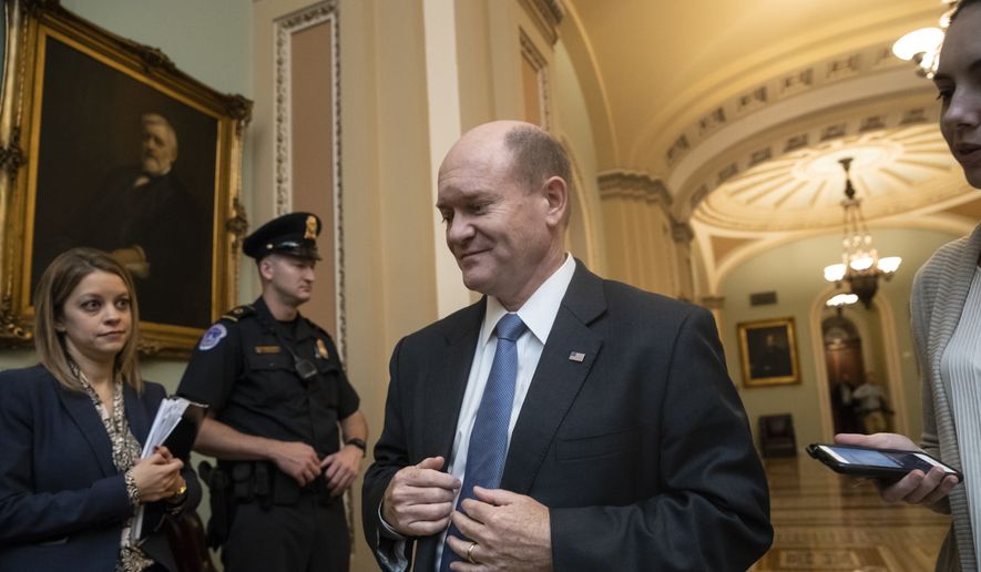 Sen. Chris Coons, D-Del., a member of the Senate Judiciary Committee, arrives at the chamber. (AP Photo/J. Scott Applewhite)
