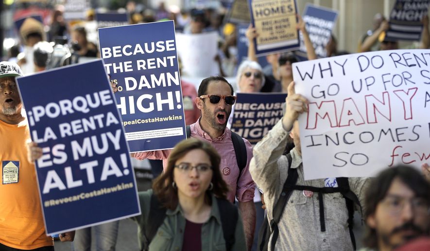 ADVANCE FOR RELEASE SATURDAY, OCT. 6, 2018, AND THEREAFTER - FILE - In this April 23, 2018, file photo rent control supporters march to the Capitol in Sacramento, Calif. Californians who rent apartments built after 1995, single-family homes or condominiums have limited protections from rising costs under a state law passed that year that restricts rent control. That could change if voters pass Proposition 10 in November. It would overturn the 1995 law and open the door to more rent control in cities and counties across the state. (AP Photo/Rich Pedroncelli, File)