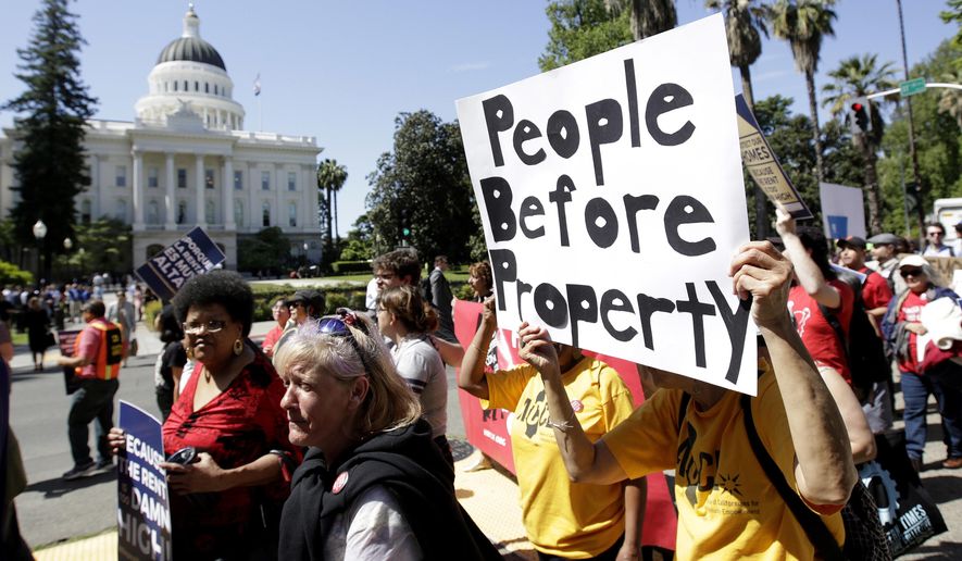ADVANCE FOR RELEASE SATURDAY, OCT. 6, 2018, AND THEREAFTER - FILE - In this April 23, 2018, file photo rent control supporters march past the Capitol in Sacramento, Calif. Californians who rent apartments built after 1995, single-family homes or condominiums have limited protections from rising costs under a state law passed that year that restricts rent control. That could change if voters pass Proposition 10 in November. It would overturn the 1995 law and open the door to more rent control in cities and counties across the state. (AP Photo/Rich Pedroncelli, File)
