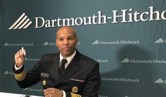 U.S. Surgeon General Jerome Adams holds up a nasal spray dose of naloxone, an opioid overdose-reversing drug in Concord, N.H., on Friday, Oct. 5, 2018. Adams was the keynote speaker at a conference organized by Dartmouth-Hitchcock Medical Center about the effects of the opioid crisis on children and families. (AP Photo/Holly Ramer) ** FILE **