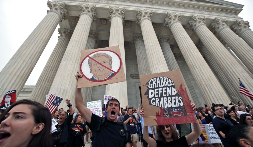 People protest on the steps of the Supreme Court after the confirmation vote of Supreme Court nominee Brett Kavanaugh, on Capitol Hill, Saturday, Oct. 6, 2018 in Washington. (AP Photo/Alex Brandon)