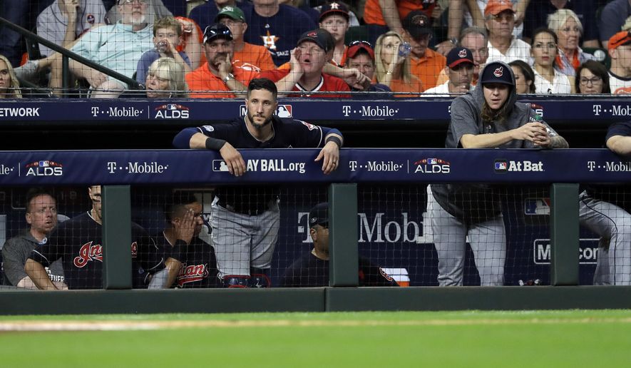 Cleveland Indians players stand in the dugout as they fall to the Houston Astros in Game 2 of a baseball American League Division Series, Saturday, Oct. 6, 2018, in Houston. (AP Photo/David J. Phillip)