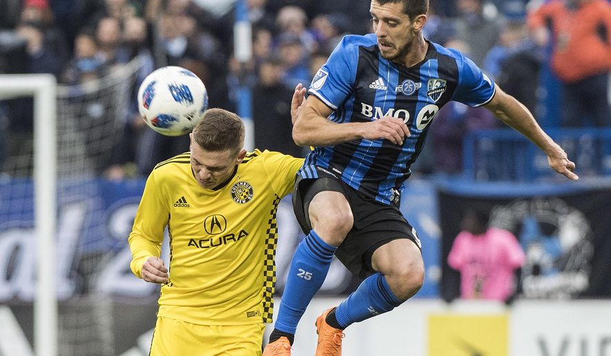 Montreal Impact&#39;s Alejandro Silva, right, challenges Columbus Crew SC&#39;s Wil Trapp during second half MLS soccer action in Montreal, Saturday, Oct. 6, 2018. (Graham Hughes/The Canadian Press via AP)