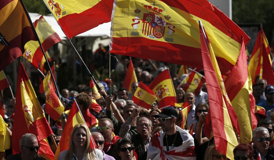 Demonstrators protest holding Spanish flags in Madrid, Spain, Saturday, Oct. 6, 2018. A few thousand Spaniards have protested in Madrid against the Socialist-led government at a rally organize by marginal right-wing groups. (AP Photo/Manu Fernandez)