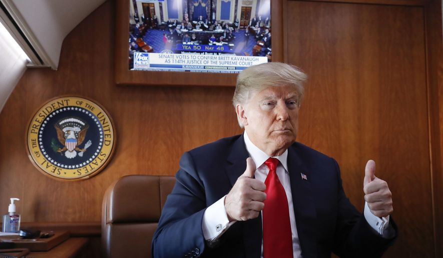President Donald Trump, on board Air Force One, gives a &#39;thumbs-up&#39; while watching a live television broadcast of the Senate confirmation vote of Supreme Court nominee Brett Kavanaugh, Saturday, Oct. 6, 2018. Trump was traveling from Washington enroute to Topeka, Kan., for a campaign rally. (AP Photo/Pablo Martinez Monsivais)