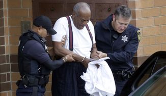 FILE - In a Tuesday Sept. 25, 2018 file photo, Bill Cosby is escorted out of the Montgomery County Correctional Facility, in Eagleville, Pa., following his sentencing to three-to-10-year prison sentence for sexual assault. Cosby’s lawyers want a court to overturn the actor’s conviction and three- to 10-year sentence in his Pennsylvania sex assault case because of what they call a string of trial errors. The defense motion argues that trial Judge Steven O’Neill erred in declaring Cosby a sexually violent predator who should be imprisoned to protect the community. (AP Photo/Jacqueline Larma, File)