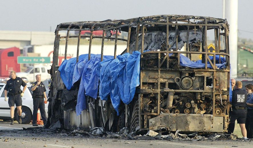 FILE - In this Friday, Sept. 23, 2005, file photo, emergency crews investigate the scene where a bus carrying about 45 elderly Hurricane Rita evacuees from the Houston area caught fire and exploded on northbound Interstate 45, in Wilmer, Texas. The accident was one of the nation's deadliest. A limousine carrying 18 people crashed Saturday, Oct. 6, 2018, in upstate New York, killing all the occupants and two pedestrians, making it among the nation’s deadliest ground-traffic accidents. (AP Photo/Matt Slocum, File)