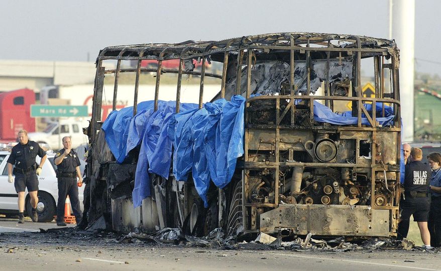 FILE - In this Friday, Sept. 23, 2005, file photo, emergency crews investigate the scene where a bus carrying about 45 elderly Hurricane Rita evacuees from the Houston area caught fire and exploded on northbound Interstate 45, in Wilmer, Texas. The accident was one of the nation's deadliest. A limousine carrying 18 people crashed Saturday, Oct. 6, 2018, in upstate New York, killing all the occupants and two pedestrians, making it among the nation’s deadliest ground-traffic accidents. (AP Photo/Matt Slocum, File)